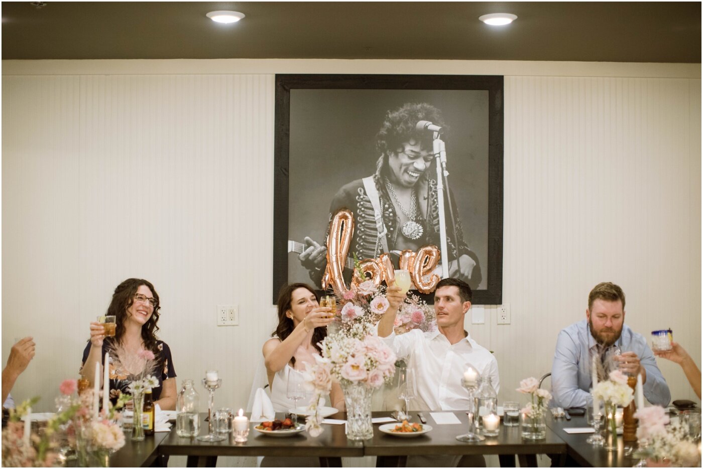 newlyweds enjoying a meal with their wedding guests