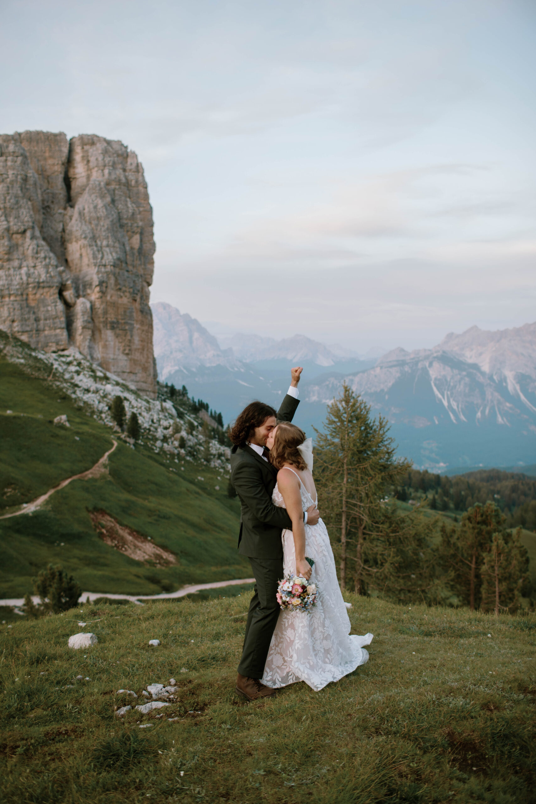 Yelena and Alex’s August rock climbing elopement in the Dolomites, Italy, was a day of adventure and connection. From climbing in wedding attire to exchanging vows at alpenglow in Cinque Torri, their Cortina d’Ampezzo celebration was unforgettable—a perfect blend of spontaneity, beauty, and love.